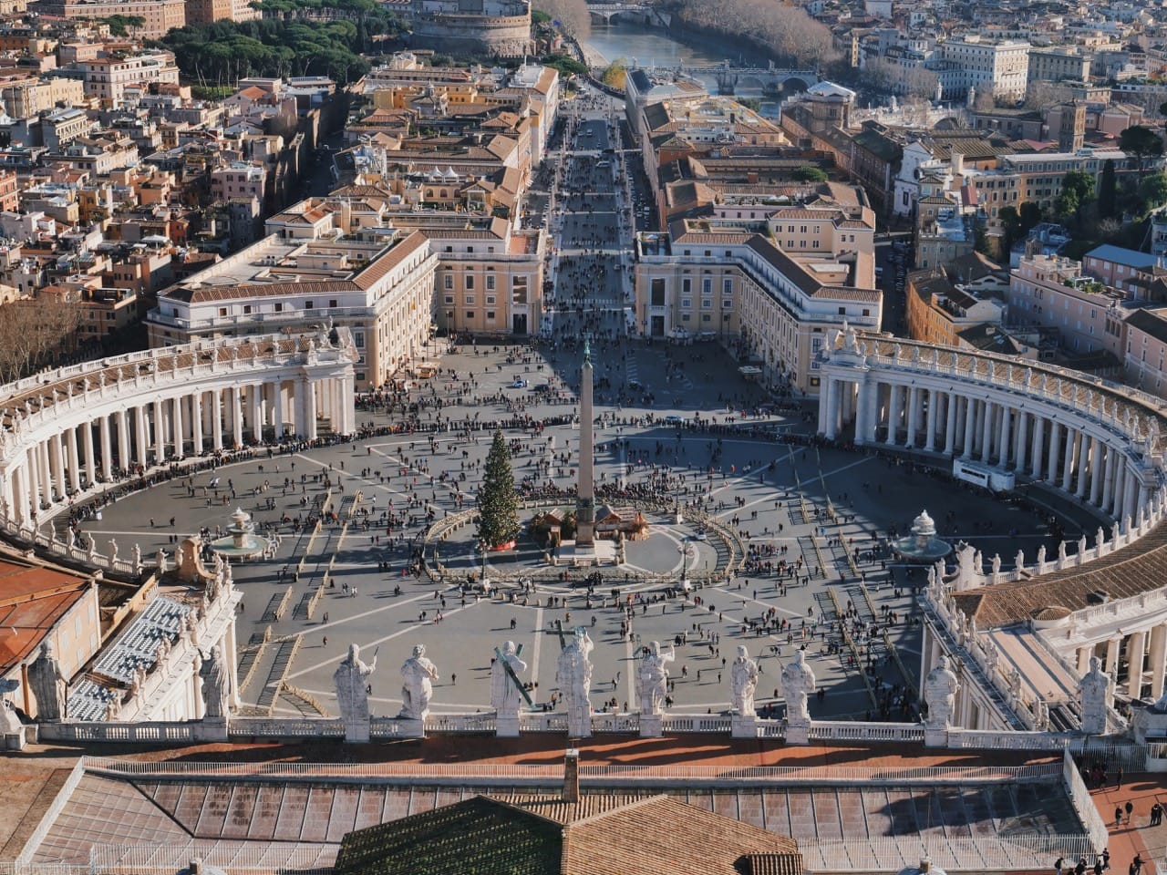 view from the top of St Peter's Basilica overlooking the obelisk and crowds below 